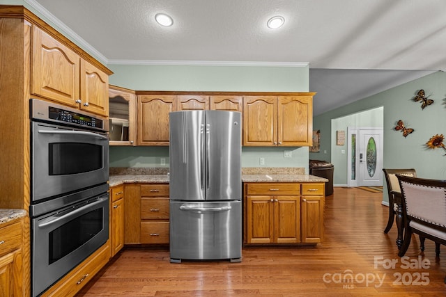 273 Bluebird Rd, Lake Lure, NC 28746 - kitchen featuring stainless steel appliances, light stone counters, wood finished floors, crown molding, and a textured ceiling