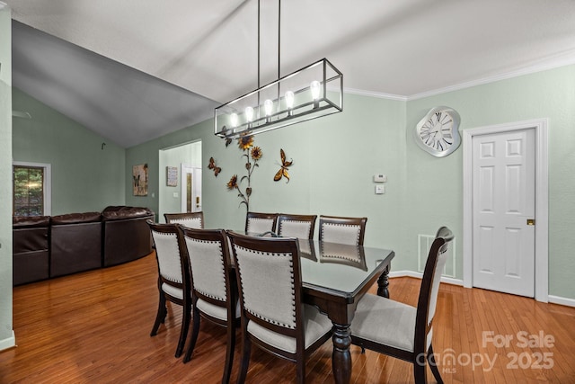 273 Bluebird Rd, Lake Lure, NC 28746 - dining room featuring wood finished floors, ornamental molding, baseboards, and vaulted ceiling