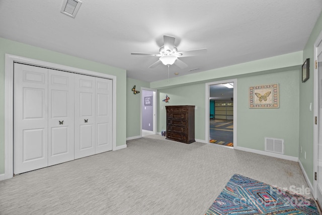 273 Bluebird Rd, Lake Lure, NC 28746 - unfurnished bedroom featuring a closet, carpet, baseboards, and a ceiling fan