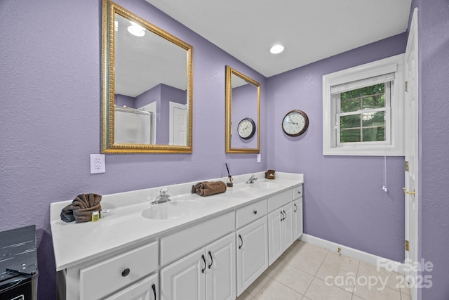 273 Bluebird Rd, Lake Lure, NC 28746 - full bath featuring tile patterned flooring, double vanity, baseboards, a shower with shower door, and a textured wall