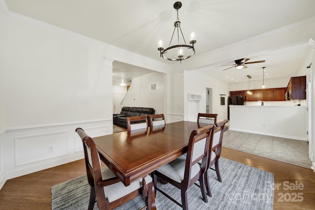 2117 Seabrook Ln, Fort Mill, SC 29715 - dining room with light wood-style flooring, a chandelier, ornamental molding, wainscoting, and a ceiling fan