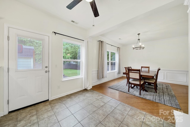 2117 Seabrook Ln, Fort Mill, SC 29715 - dining space with light tile patterned floors, a chandelier, a decorative wall, ceiling fan, and a wainscoted wall
