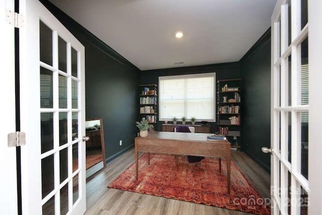 home office featuring french doors, wood finished floors, crown molding, and recessed lighting