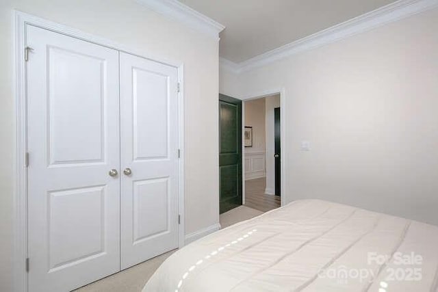 bedroom featuring ornamental molding and a closet