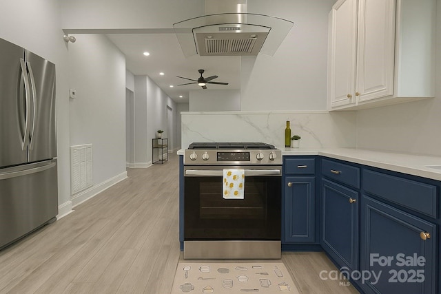 kitchen with stainless steel appliances, blue cabinets, white cabinetry, light wood-type flooring, and light countertops