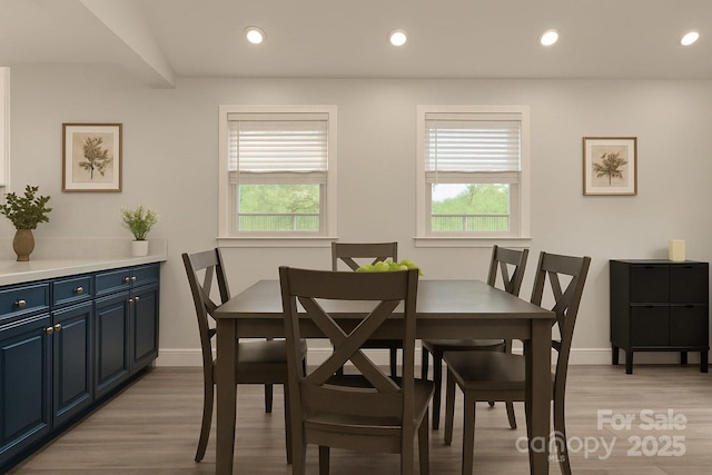 dining room featuring plenty of natural light, light wood-style flooring, baseboards, and recessed lighting