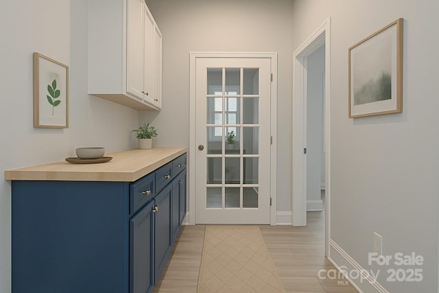 entryway with light wood-style flooring and baseboards