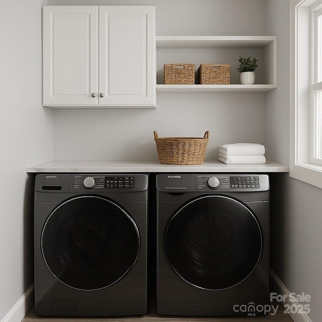 laundry area with washer and clothes dryer, cabinet space, and baseboards