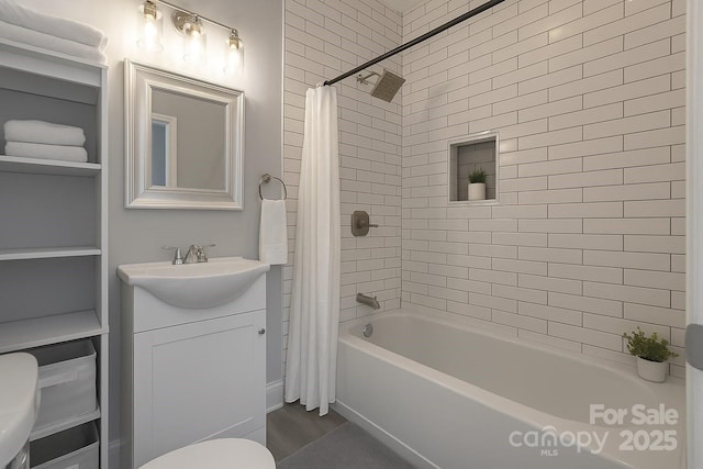 full bathroom with shower / tub combo, toilet, and vanity