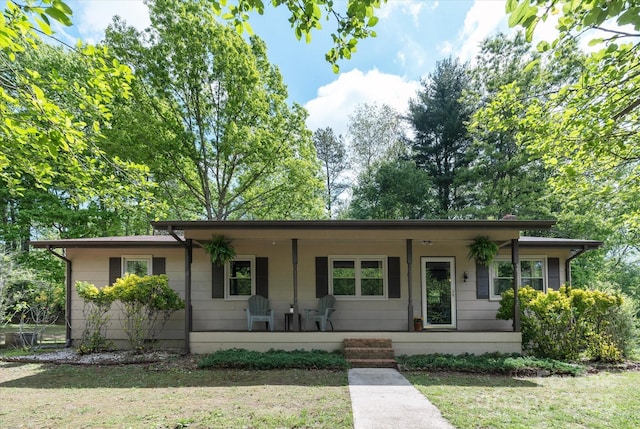 view of front of house with a porch and a front yard