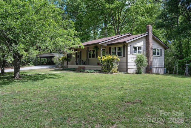 ranch-style house featuring a chimney, a front lawn, driveway, covered porch, and a carport