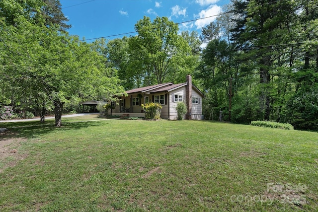 view of grassy yard with a carport
