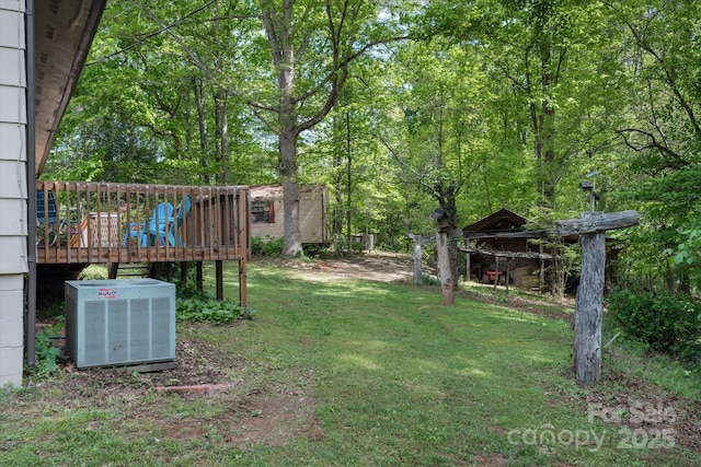 view of grassy yard with cooling unit and a wooden deck
