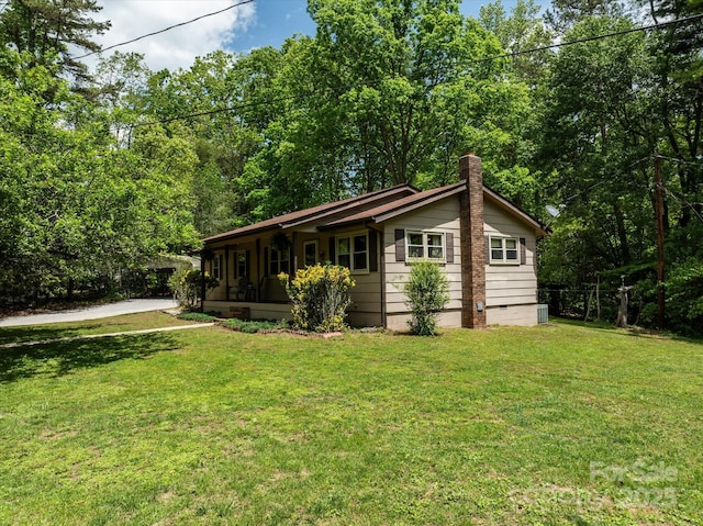 view of front of home featuring a front yard and a chimney
