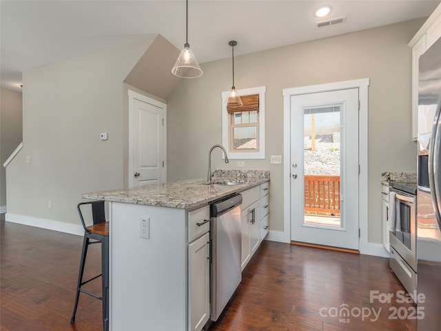41 Wheeler Rd, Weaverville, NC 28787 - kitchen with a sink, stainless steel appliances, a peninsula, a breakfast bar area, and dark wood-type flooring