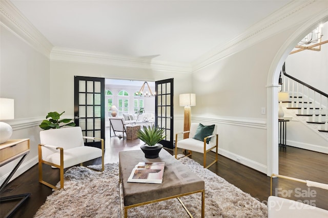 7812 Seton House Ln, Charlotte, NC 28277 - living room featuring ornamental molding, stairway, wood finished floors, a chandelier, and arched walkways
