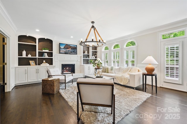 7812 Seton House Ln, Charlotte, NC 28277 - living area featuring crown molding, healthy amount of natural light, a chandelier, a fireplace, and dark wood-style floors