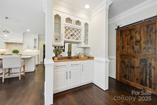 7812 Seton House Ln, Charlotte, NC 28277 - indoor wet bar with dark wood-style floors, decorative backsplash, crown molding, recessed lighting, and wainscoting