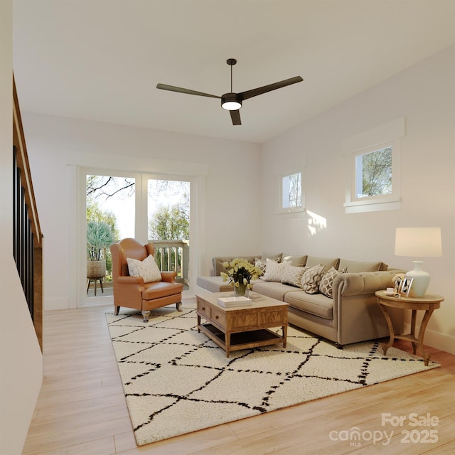 living room with healthy amount of natural light, light wood-style flooring, a ceiling fan, and baseboards