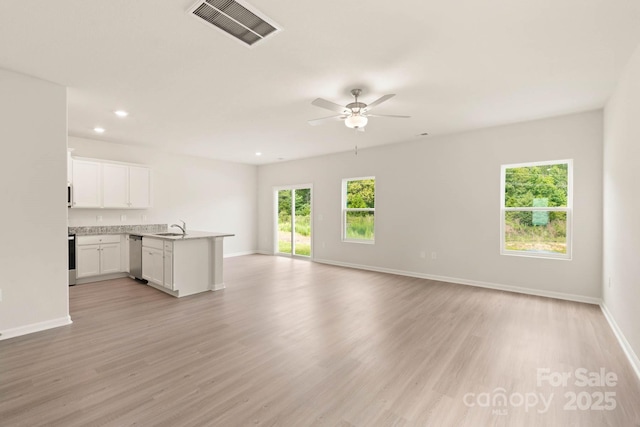 3342 Strong Box Ln, Gastonia, NC 28052 - unfurnished living room with a sink, light wood finished floors, baseboards, a ceiling fan, and recessed lighting