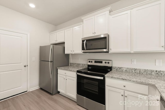 3342 Strong Box Ln, Gastonia, NC 28052 - kitchen featuring appliances with stainless steel finishes, light wood-style floors, white cabinetry, recessed lighting, and baseboards