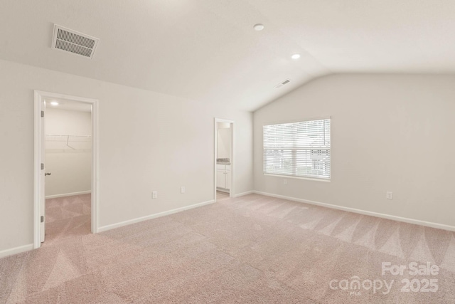 3342 Strong Box Ln, Gastonia, NC 28052 - unfurnished bedroom with a walk in closet, vaulted ceiling, carpet flooring, baseboards, and ensuite bath