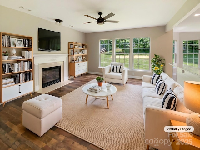 10406 Baskerville Ave, Charlotte, NC 28269 - living room featuring wood finished floors, a fireplace with flush hearth, a ceiling fan, and baseboards
