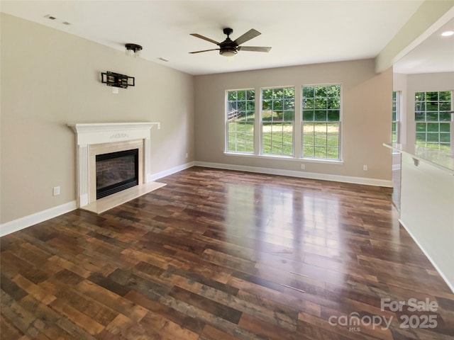 10406 Baskerville Ave, Charlotte, NC 28269 - unfurnished living room with a high end fireplace, a ceiling fan, baseboards, and dark wood-type flooring
