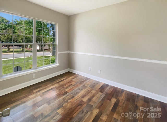 10406 Baskerville Ave, Charlotte, NC 28269 - empty room with dark wood-style floors, healthy amount of natural light, and baseboards