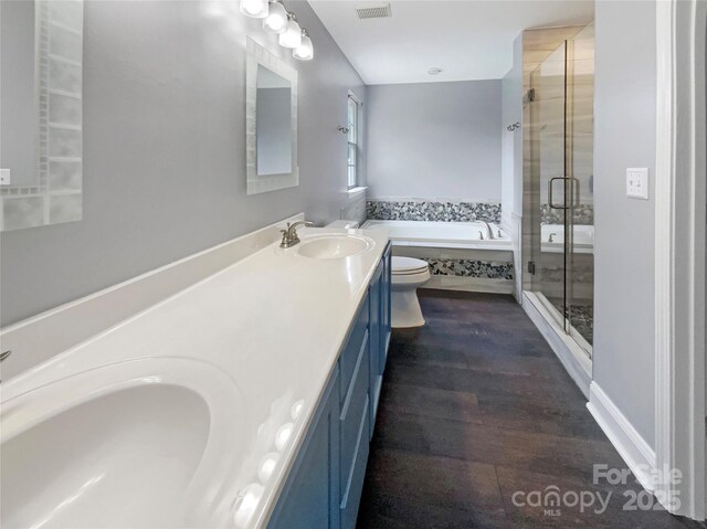 10406 Baskerville Ave, Charlotte, NC 28269 - bathroom featuring a garden tub, a shower stall, double vanity, and wood finished floors
