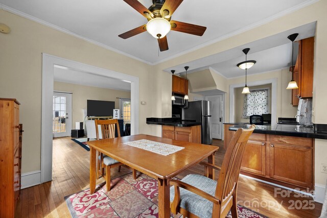 45 Woodvale Ave, Asheville, NC 28804 - dining room with light wood finished floors, a ceiling fan, ornamental molding, and baseboards