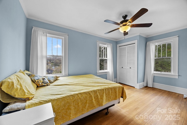 45 Woodvale Ave, Asheville, NC 28804 - bedroom with baseboards, crown molding, hardwood / wood-style flooring, a closet, and ceiling fan