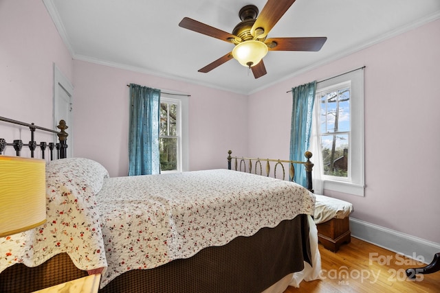 45 Woodvale Ave, Asheville, NC 28804 - bedroom featuring multiple windows, wood finished floors, crown molding, baseboards, and a ceiling fan