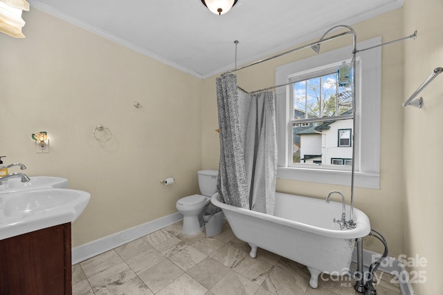 45 Woodvale Ave, Asheville, NC 28804 - full bath featuring baseboards, a freestanding tub, crown molding, toilet, and double vanity