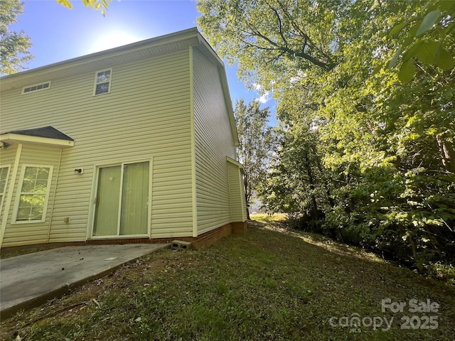 rear view of property featuring a patio area