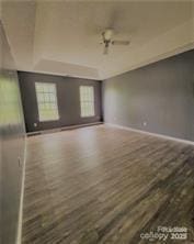 empty room featuring wood finished floors and baseboards