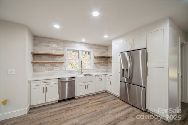 26056 Neptunes Lndg, Fort Mill, SC 29708 - kitchen featuring open shelves, stainless steel appliances, backsplash, light wood-style floors, and white cabinets