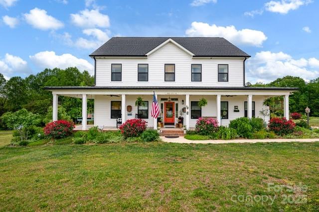 view of front of home featuring a front yard and a porch