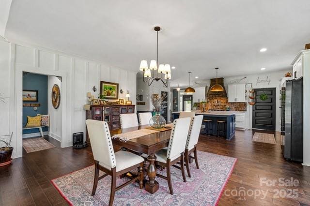 dining room featuring a chandelier, dark wood finished floors, and recessed lighting