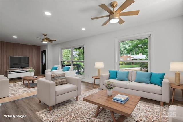 living room featuring a ceiling fan, healthy amount of natural light, wood finished floors, recessed lighting, and baseboards