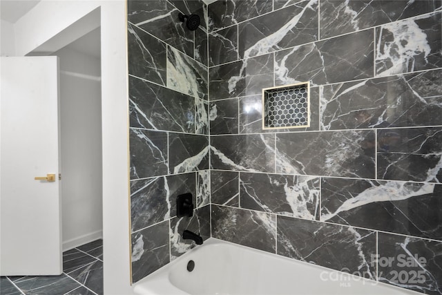 full bath with marble look tiles, shower / washtub combination, and baseboards