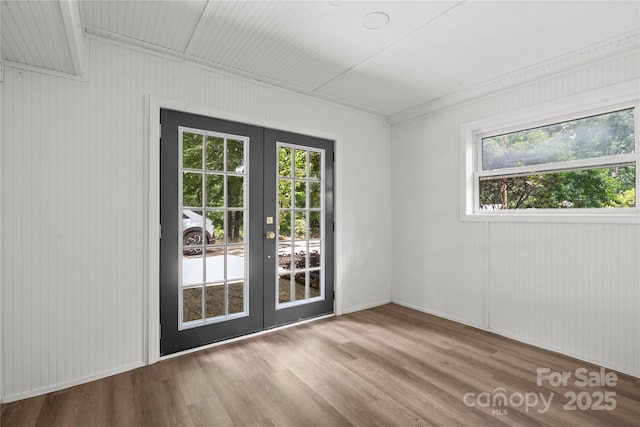 spare room with french doors and wood finished floors