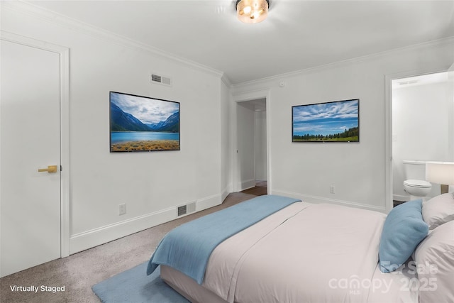 carpeted bedroom featuring crown molding, baseboards, and ensuite bath