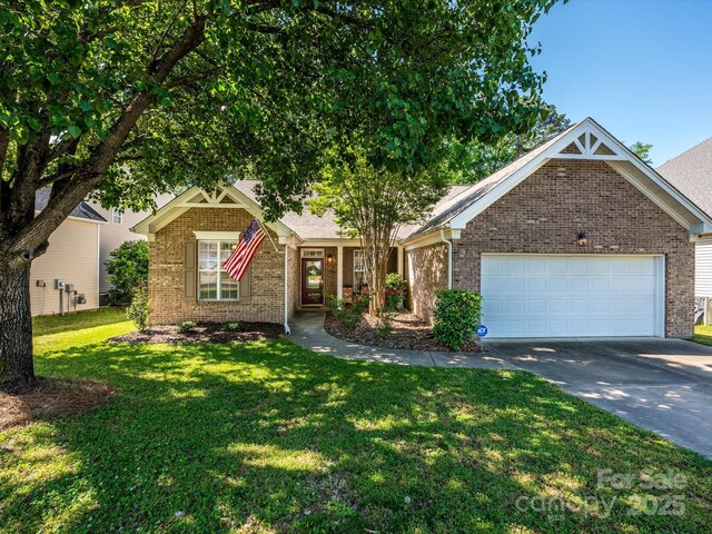 14336 Northridge Dr, Charlotte, NC 28269 - view of front of home with brick siding, concrete driveway, and a front lawn