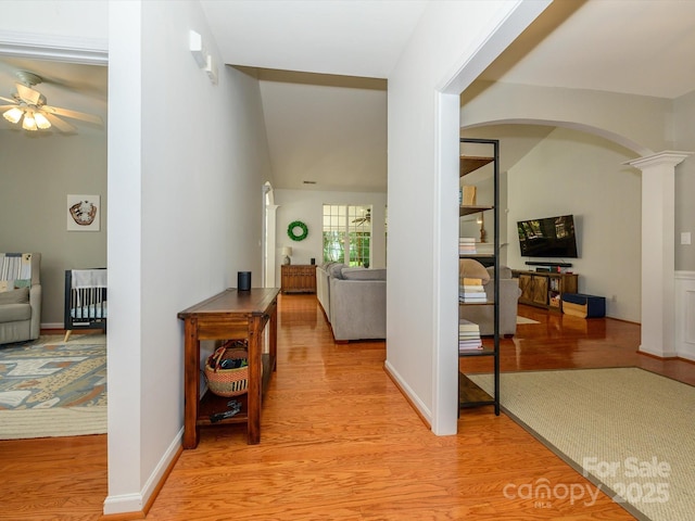 14336 Northridge Dr, Charlotte, NC 28269 - corridor featuring light wood finished floors, ornate columns, arched walkways, baseboards, and lofted ceiling