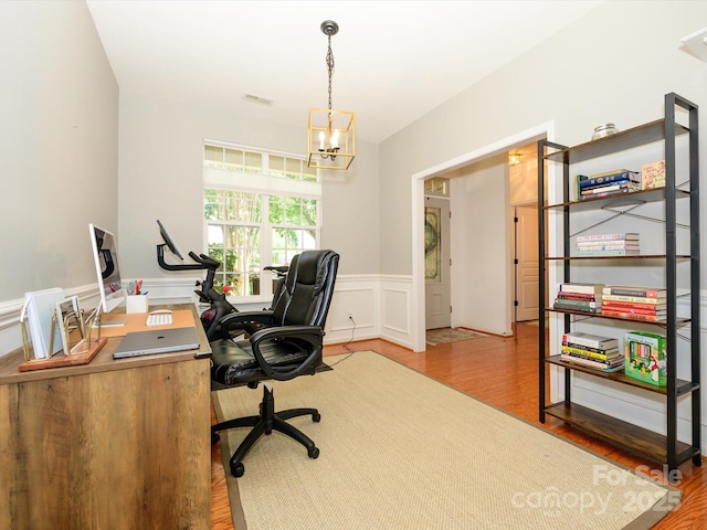 14336 Northridge Dr, Charlotte, NC 28269 - office featuring wood finished floors, wainscoting, a chandelier, and a decorative wall