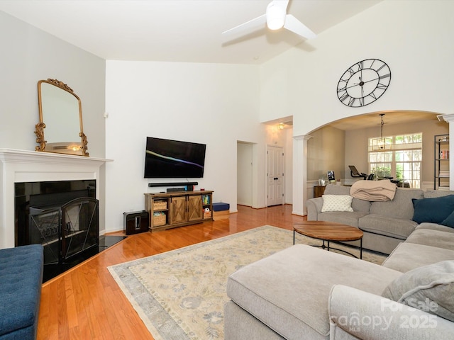 14336 Northridge Dr, Charlotte, NC 28269 - living area with decorative columns, arched walkways, ceiling fan, a chandelier, and wood finished floors