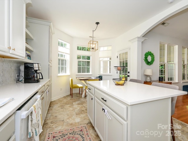 14336 Northridge Dr, Charlotte, NC 28269 - kitchen with open shelves, dishwasher, arched walkways, white cabinets, and decorative backsplash