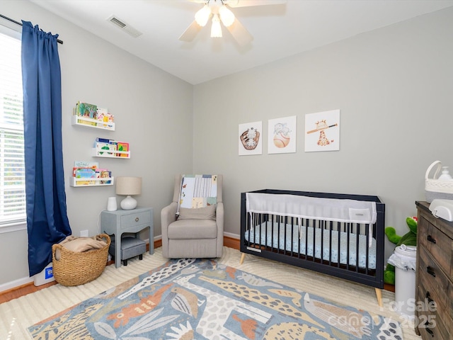 14336 Northridge Dr, Charlotte, NC 28269 - bedroom with a nursery area, baseboards, wood finished floors, and ceiling fan