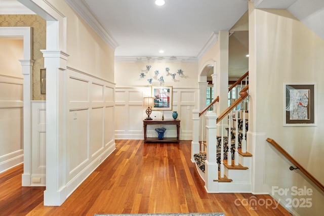 8534 Highgrove St, Charlotte, NC 28277 - hallway featuring a decorative wall, hardwood / wood-style floors, crown molding, stairs, and decorative columns